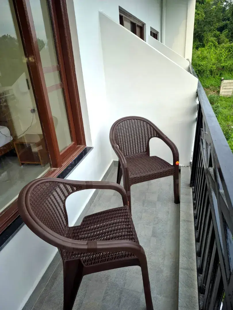Two chairs on a private balcony overlooking greenery