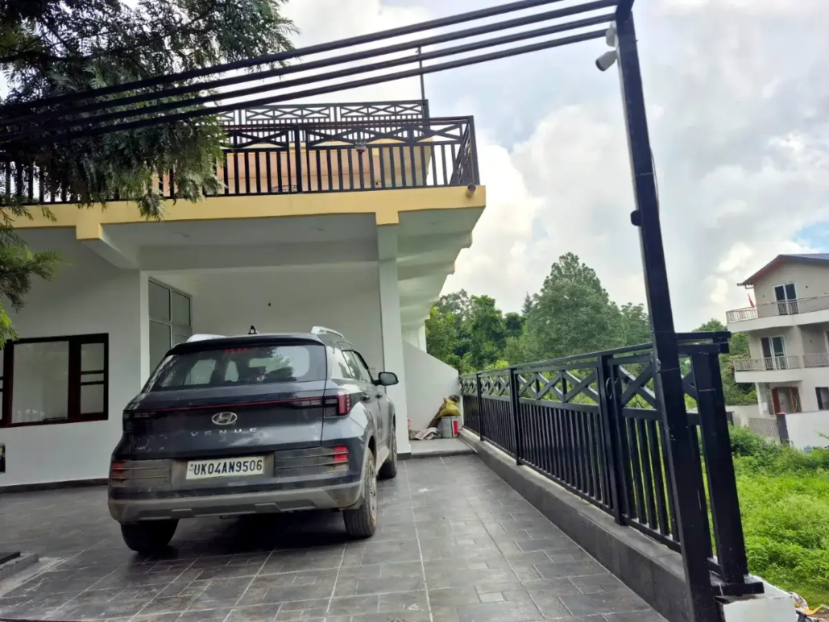 The property exterior with a car parked under the balcony