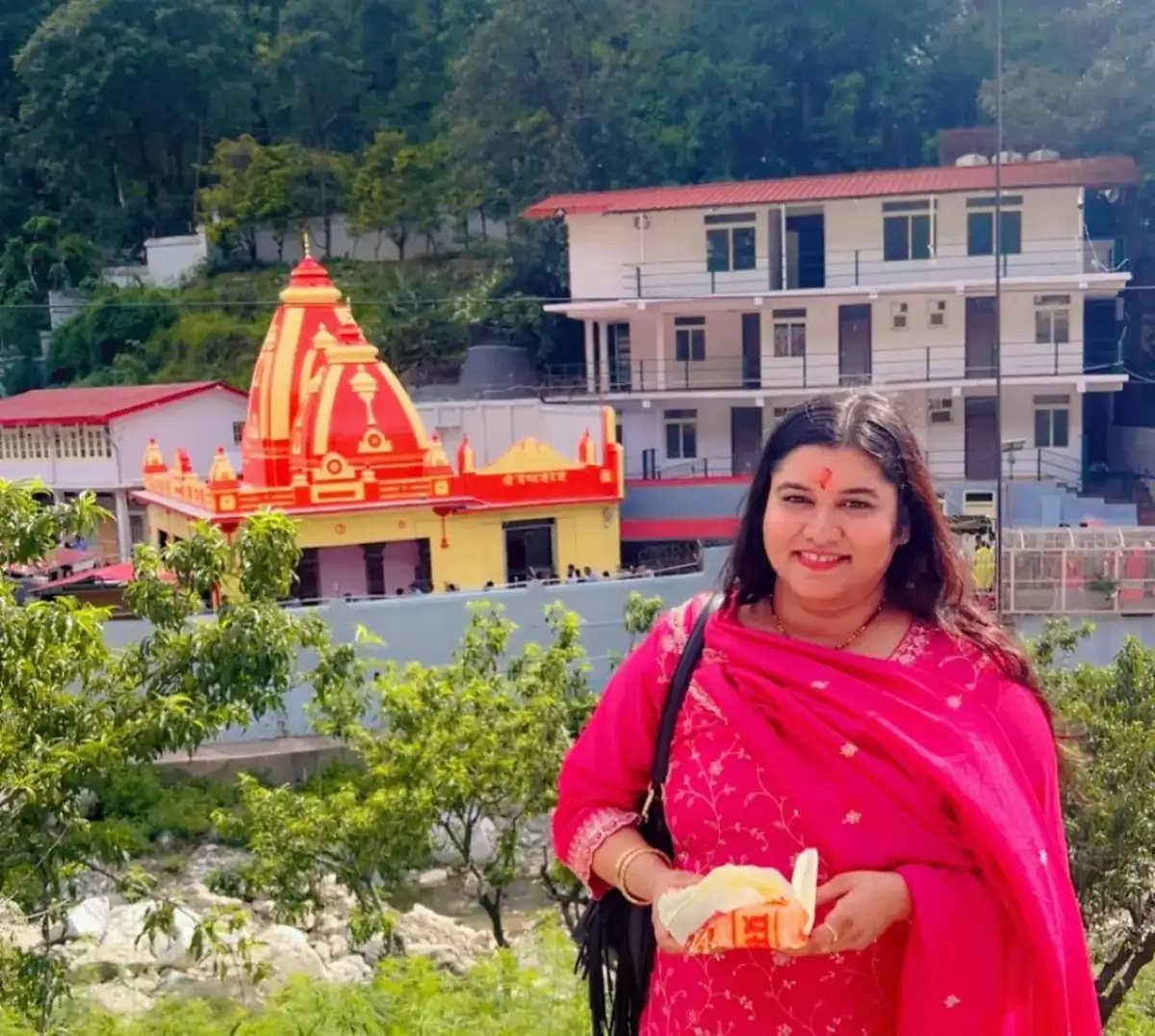 The red and gold Kainchi Dham temple in the Kumaon hills