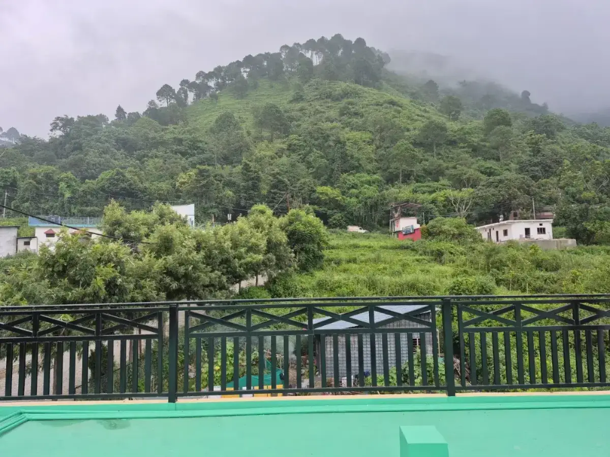 Rooftop terrace with forested hill and village